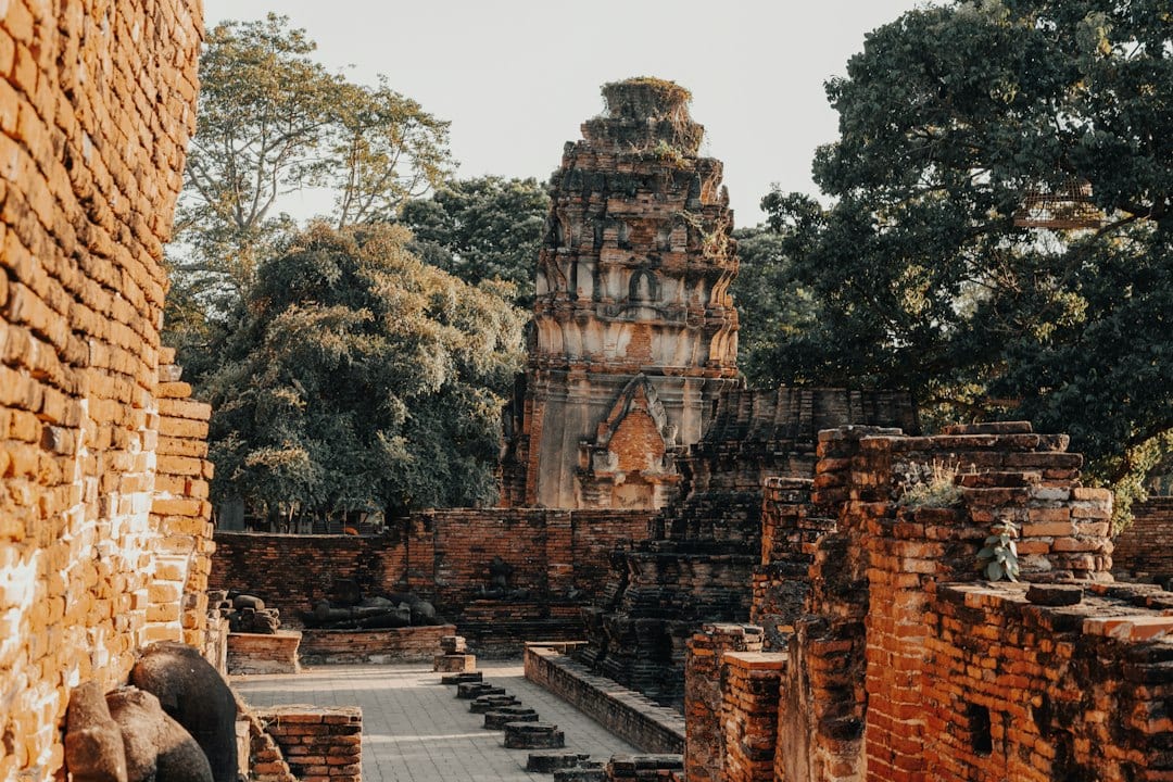 Ancient brick ruins with a central temple structure at Ayutthaya Historical Park