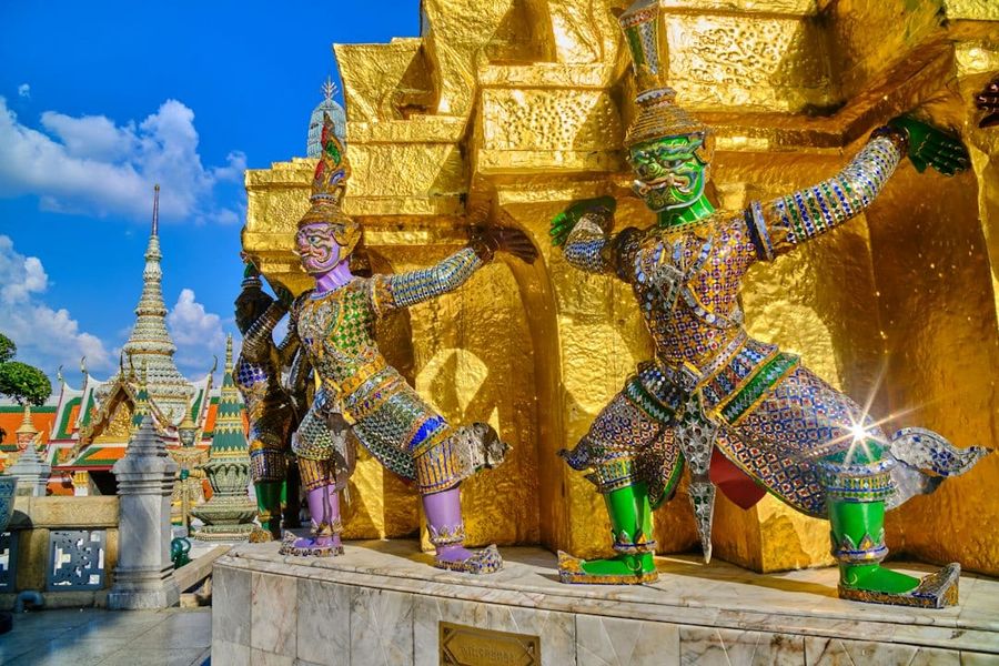 The golden spires of Bangkok's Grand Palace against a bright sky