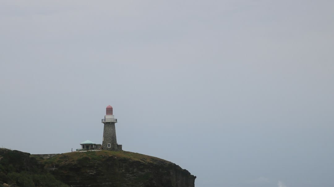 Basco Lighthouse on a green hillside in Batanes