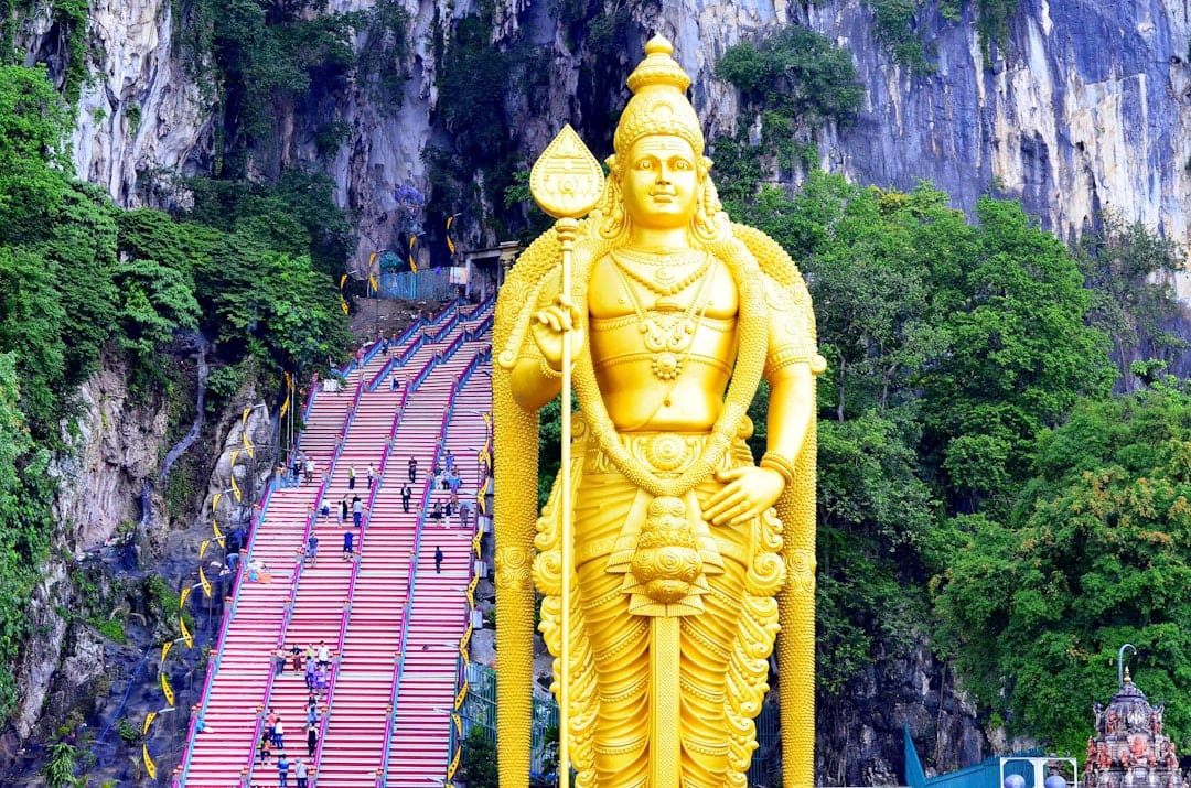 Batu Caves rainbow staircase and golden statue in Kuala Lumpur