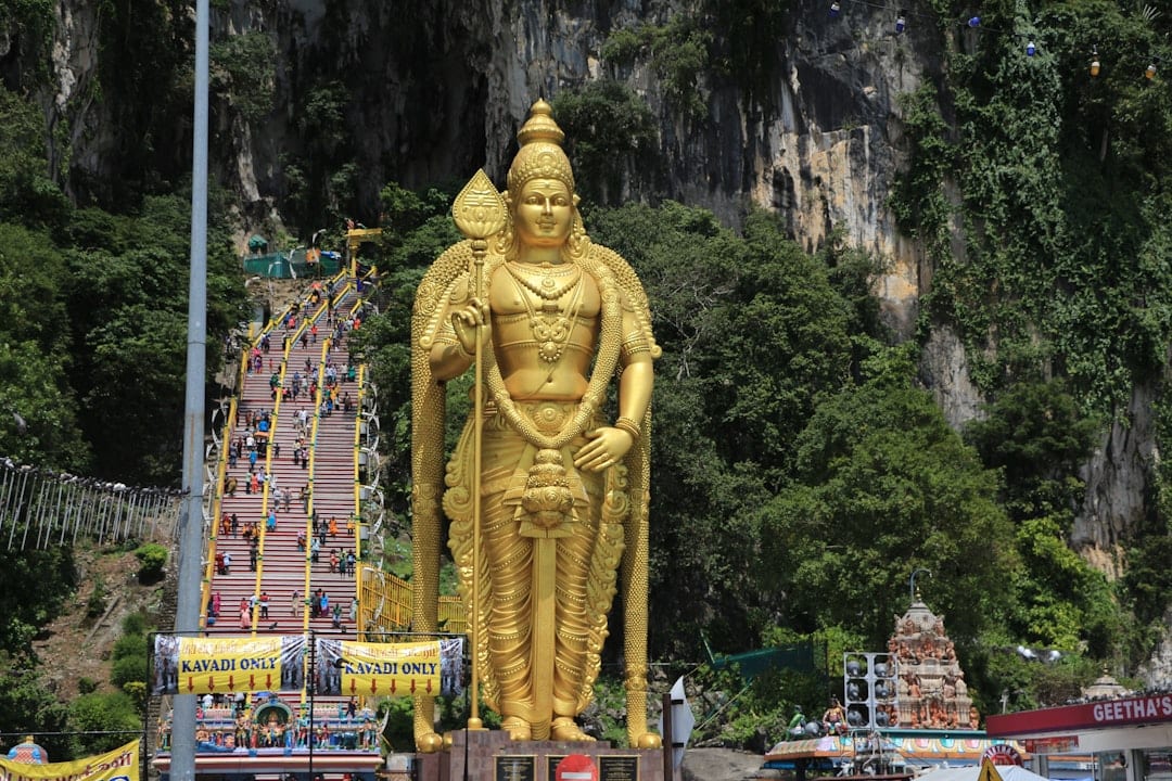 Batu Caves with its towering golden Murugan statue and colorful staircase, a must-see near Kuala Lumpur