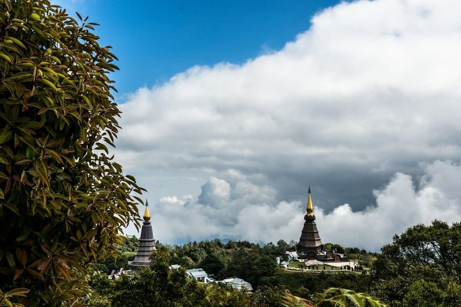 Two pagodas on a cloudy mountain landscape