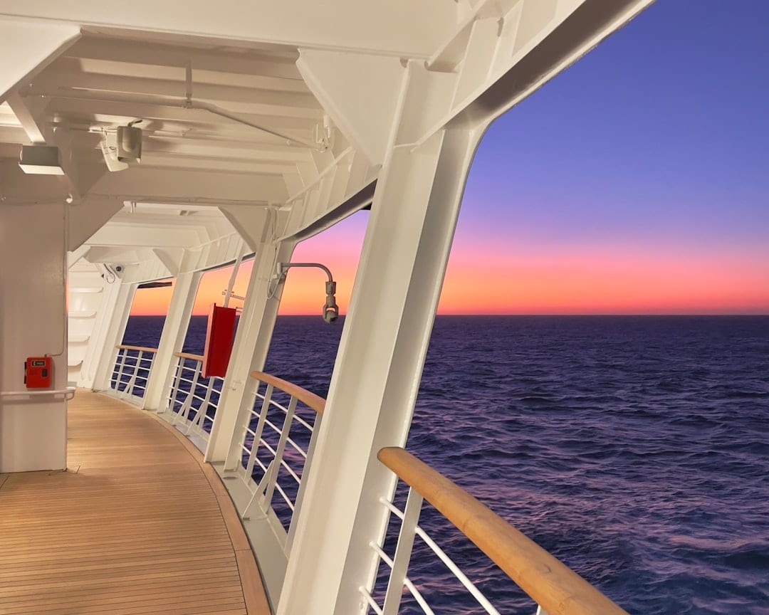 Cruise ship deck overlooking the ocean at sunset