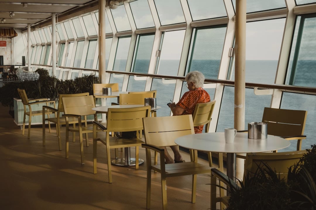 Woman sitting by the window on a cruise ship