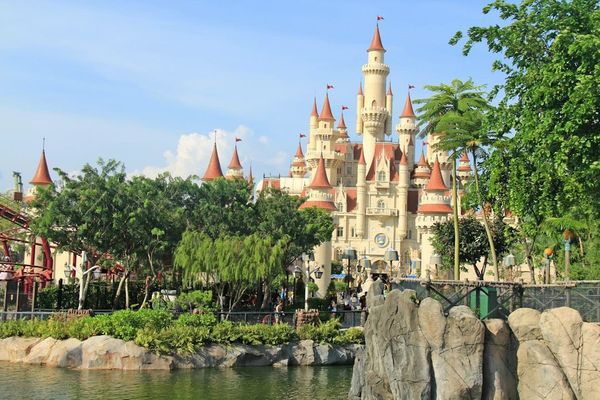 Disney Adventure cruise ship docked at Singapore with castle-inspired funnel