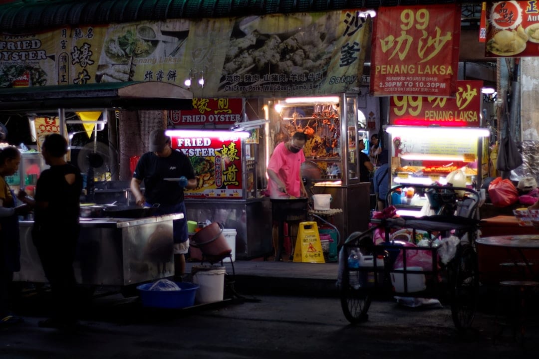 Travelers sharing a meal at a highway rest stop between Singapore and Malaysia