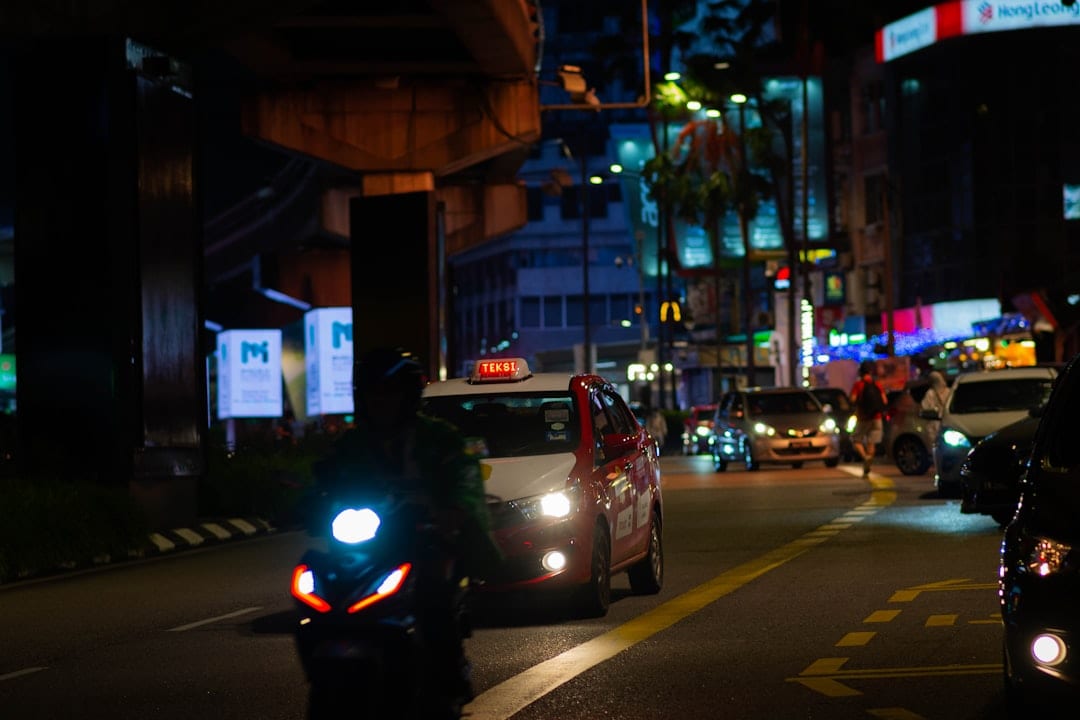 Bustling Bukit Bintang street at night with bright neon signs and shops