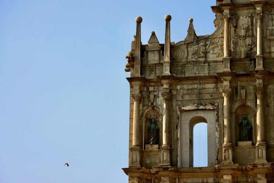Ruins of St. Paul's facade in Macau with stone steps and blue sky