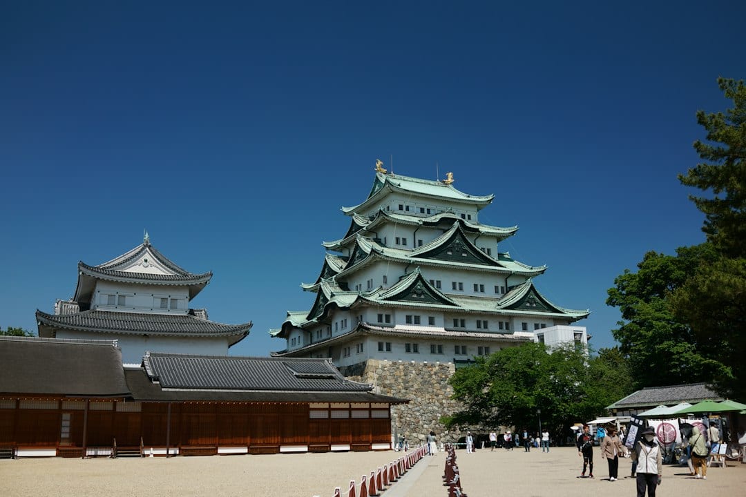 Nagoya castle stands tall against a blue sky