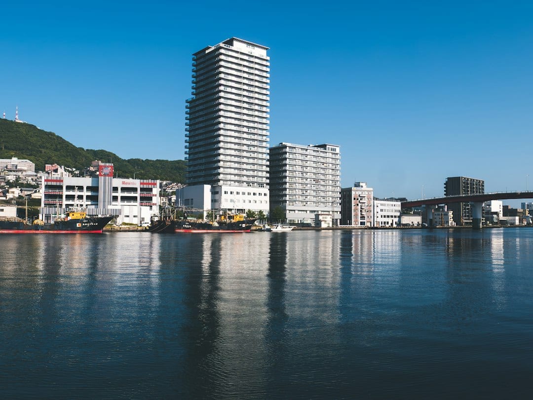Naha city skyline reflected in tranquil harbor water