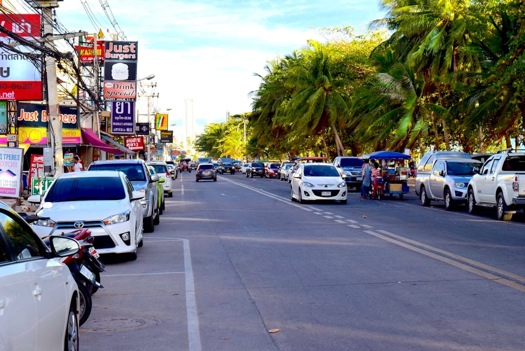Pattaya beach road with songthaew pickup trucks for local transport