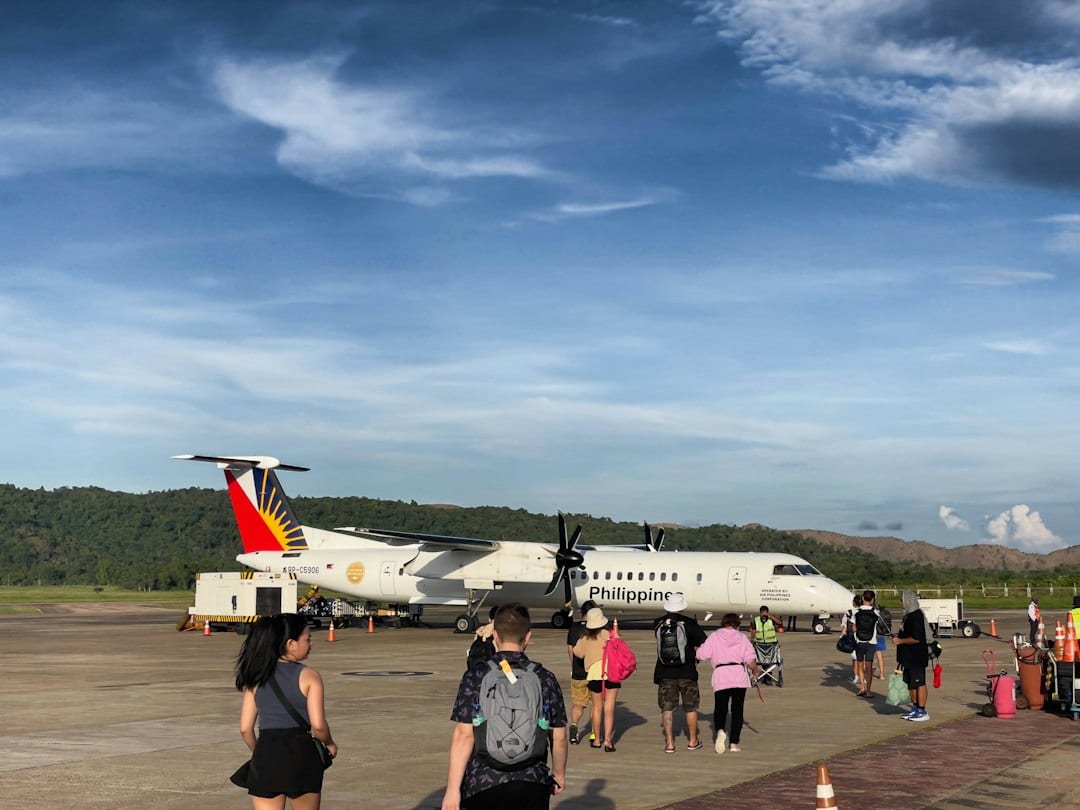 Passengers boarding a small airplane on the tarmac at a Philippine domestic airport