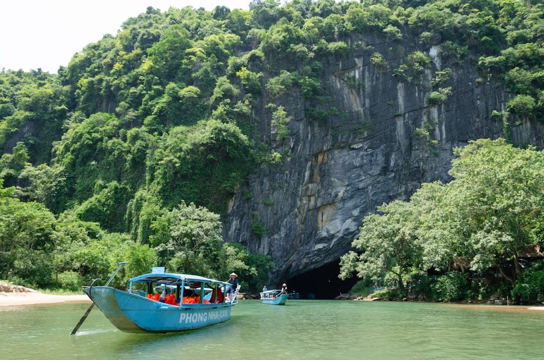 Traditional wooden rowboat carrying visitors into Phong Nha Cave along the underground river