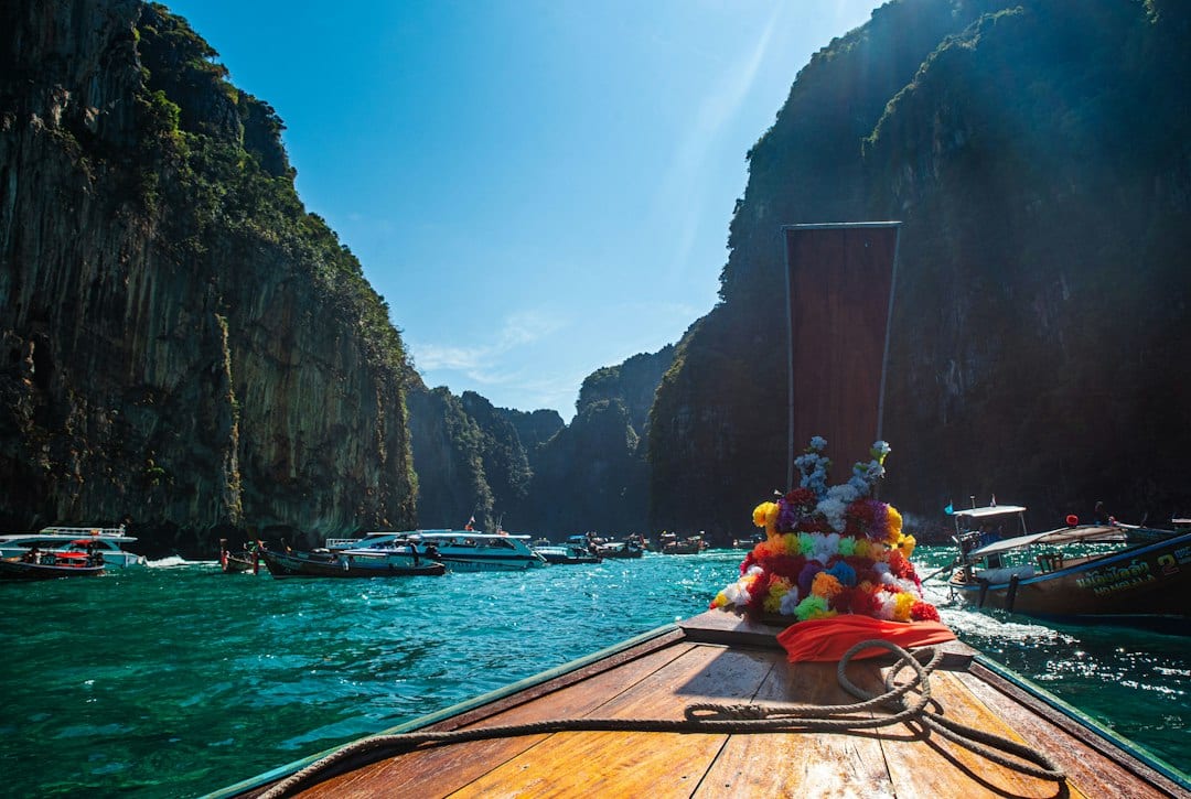 Longtail boat on the turquoise waters of Phuket with dramatic limestone karsts