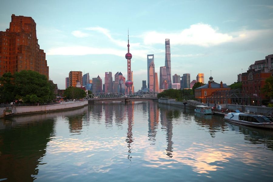 Shanghai skyline reflected in huangpu river at dusk