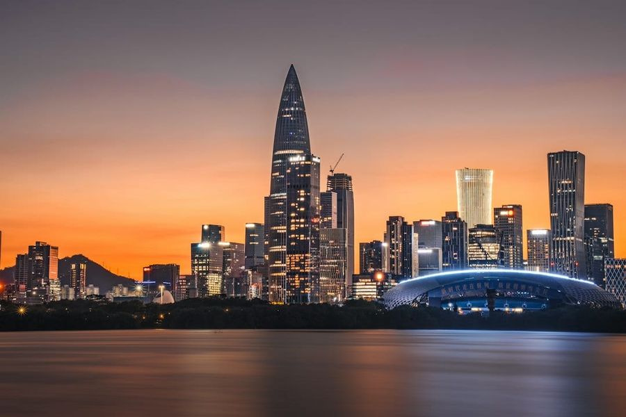 Shenzhen modern skyline with skyscrapers at sunset over water