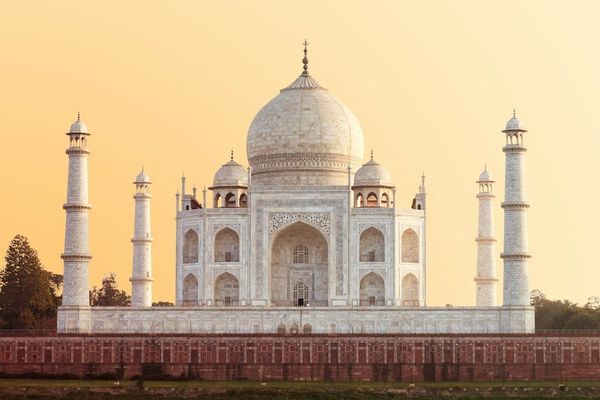 Taj Mahal in Agra under a warm golden hour sky