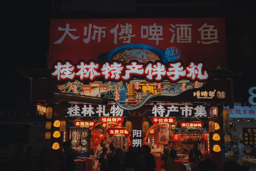 Vibrant night scene of Xi'an Muslim Quarter with traditional street food stalls and lantern-lit alleyways