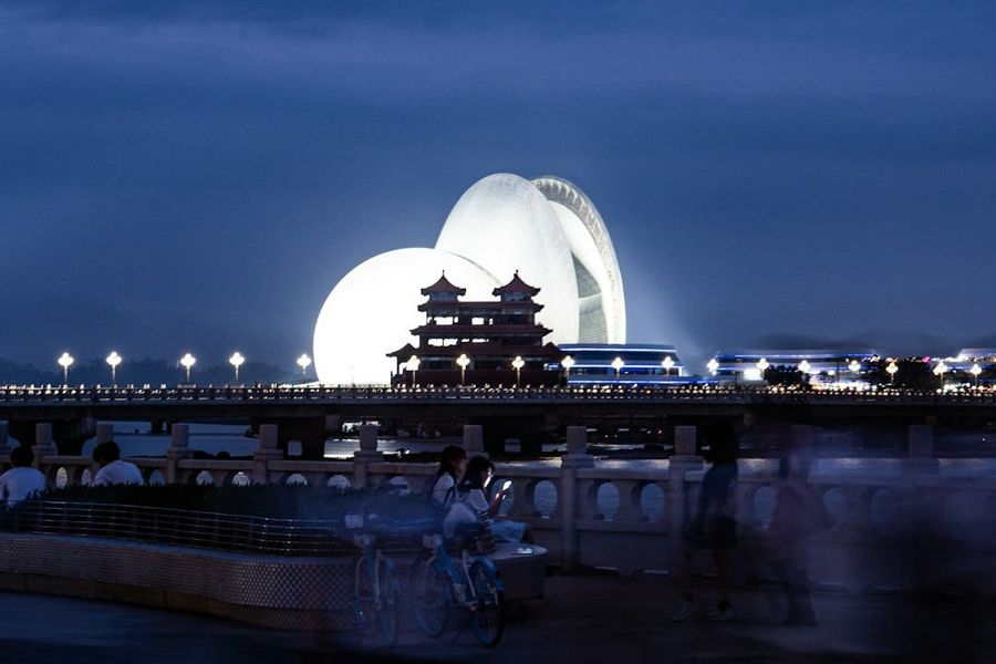 Zhuhai waterfront promenade at night with glowing modern structure